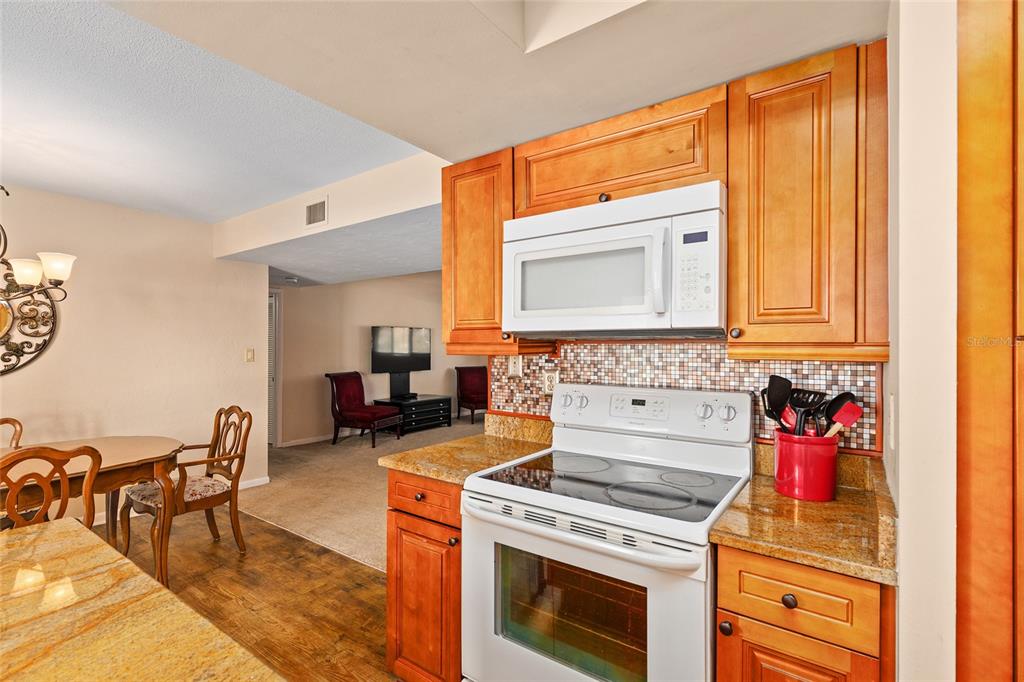 401 Northwest 39th Road, Unit 401C Gainesville, FL 32607 - Photo 15 of 62 a kitchen with a stove and a microwave