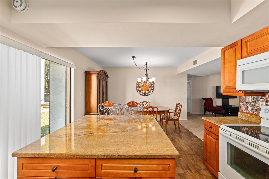 401 Northwest 39th Road, Unit 401C Gainesville, FL 32607 - Photo 16 of 62 a view of a dining room and kitchen with a table chairs