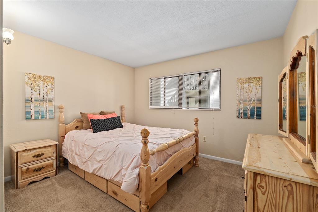 401 Northwest 39th Road, Unit 401C Gainesville, FL 32607 - Photo 18 of 62 a bedroom with a bed and a dresser