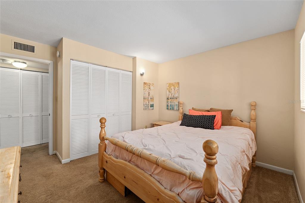 401 Northwest 39th Road, Unit 401C Gainesville, FL 32607 - Photo 19 of 62 a bedroom with a bed and wooden floor