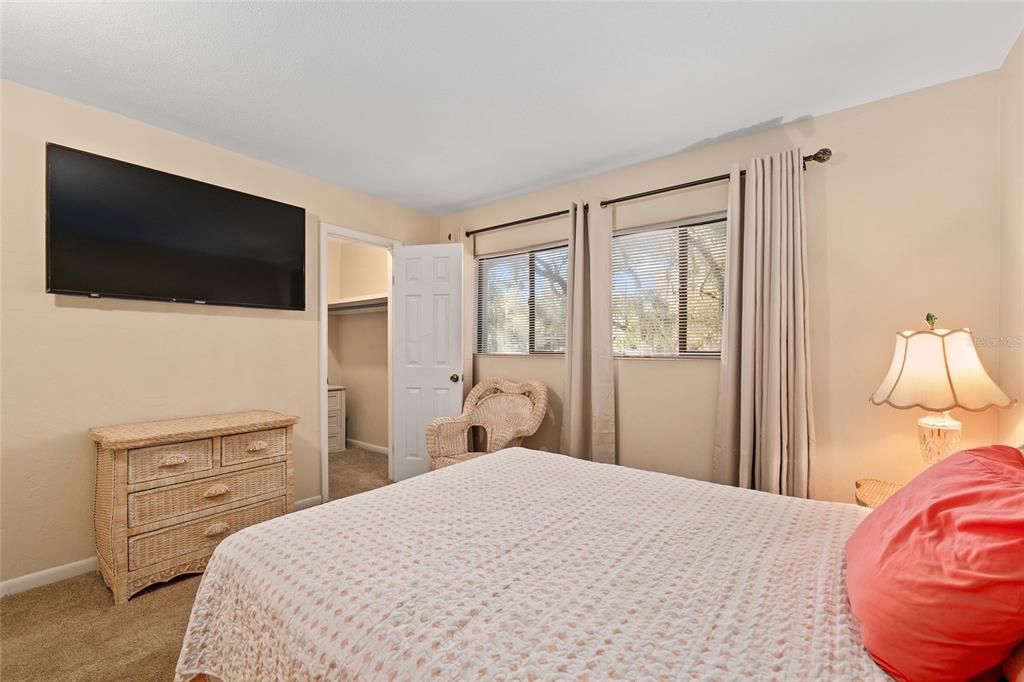 401 Northwest 39th Road, Unit 401C Gainesville, FL 32607 - Photo 23 of 62 a bedroom with a bed and a flat screen tv