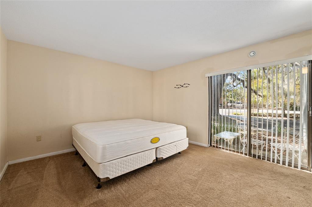 401 Northwest 39th Road, Unit 401C Gainesville, FL 32607 - Photo 27 of 62 a bed sitting in a bedroom next to a window
