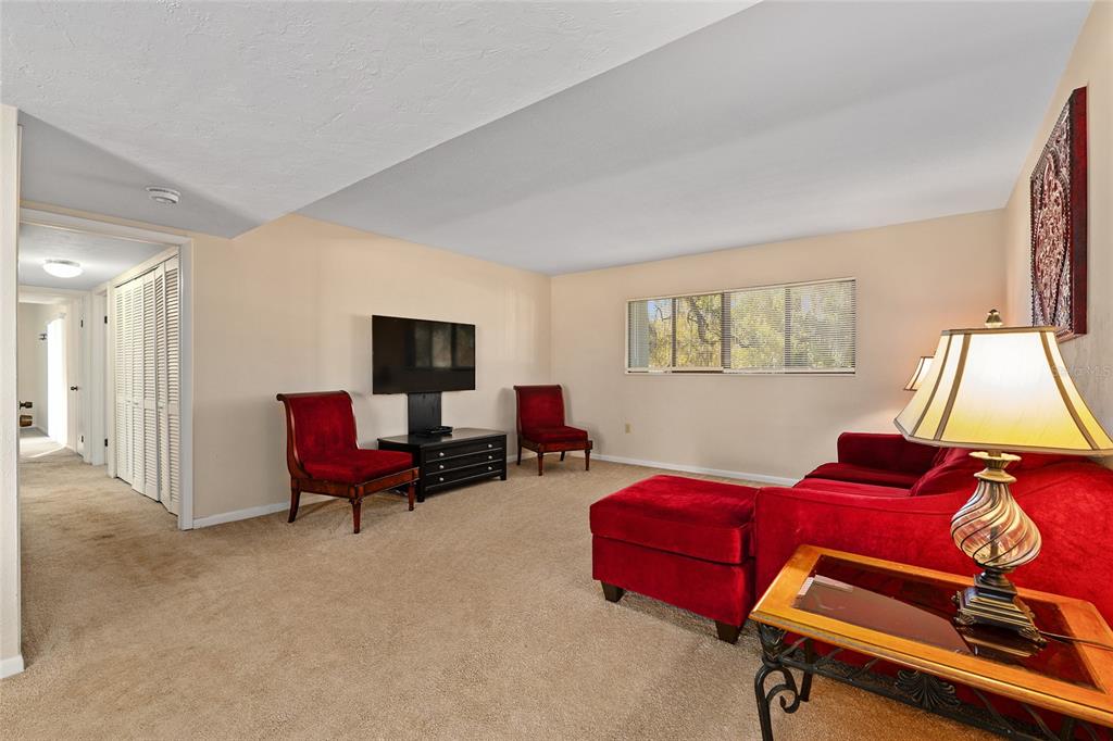 401 Northwest 39th Road, Unit 401C Gainesville, FL 32607 - Photo 4 of 62 a living room with furniture a flat screen tv and a window
