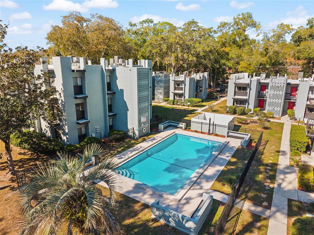 401 Northwest 39th Road, Unit 401C Gainesville, FL 32607 - Photo 60 of 62 a view of a house with backyard and sitting area