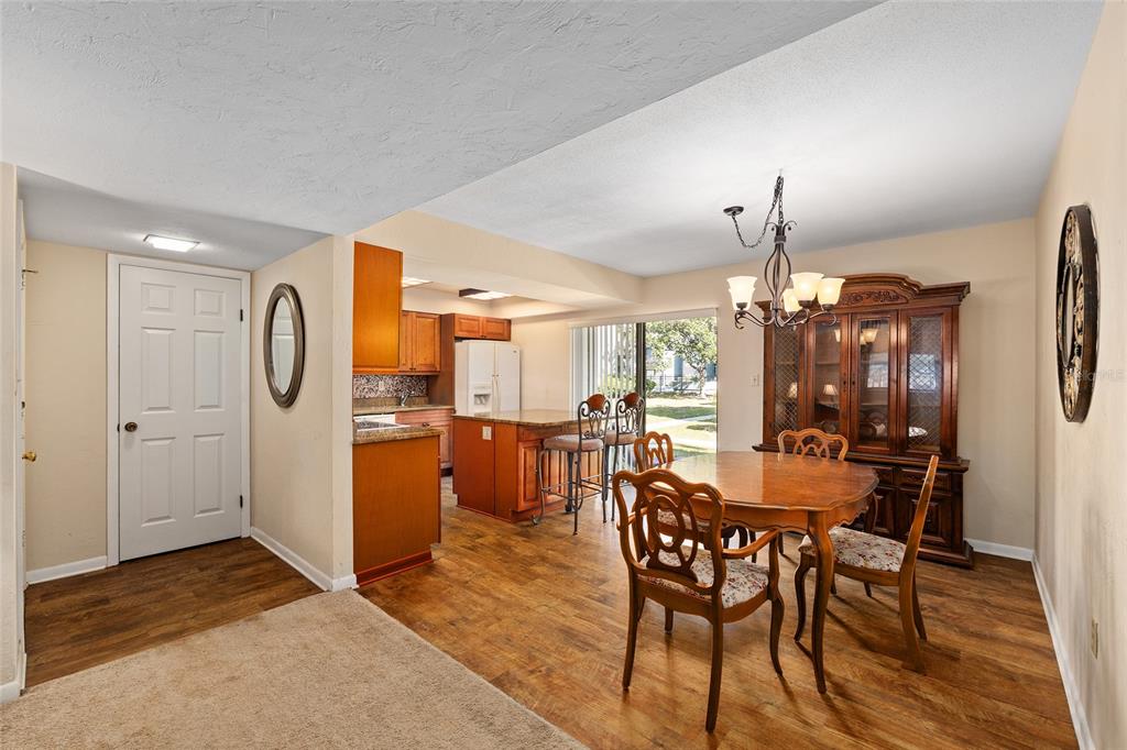 401 Northwest 39th Road, Unit 401C Gainesville, FL 32607 - Photo 8 of 62 a view of a dining room with furniture and wooden floor