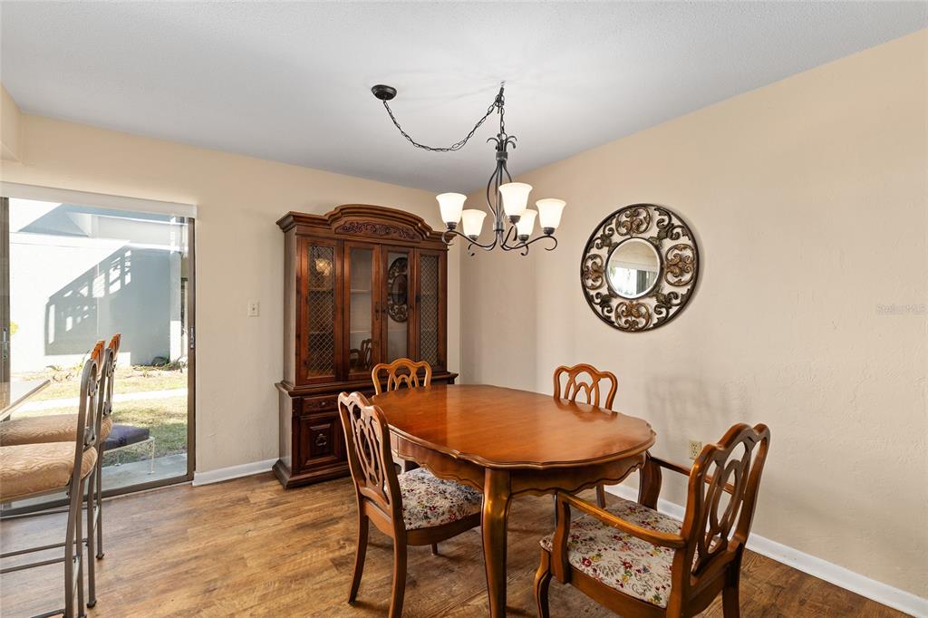 401 Northwest 39th Road, Unit 401C Gainesville, FL 32607 - Photo 9 of 62 a view of a dining room with furniture and a chandelier
