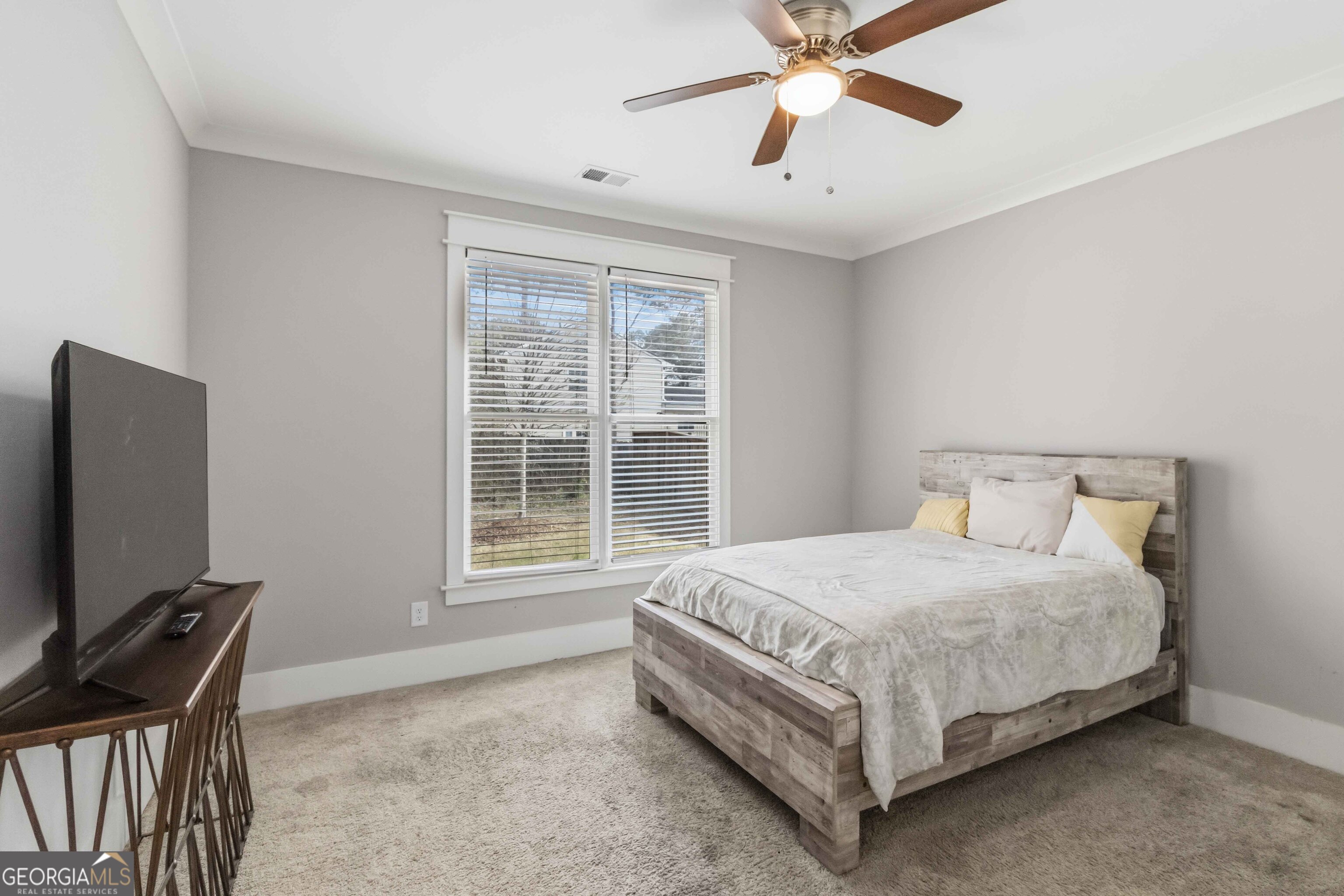 6247 Allen Ivey Road Mableton, GA 30126 - Photo 17 of 31 a bedroom with a bed window and a flat screen tv