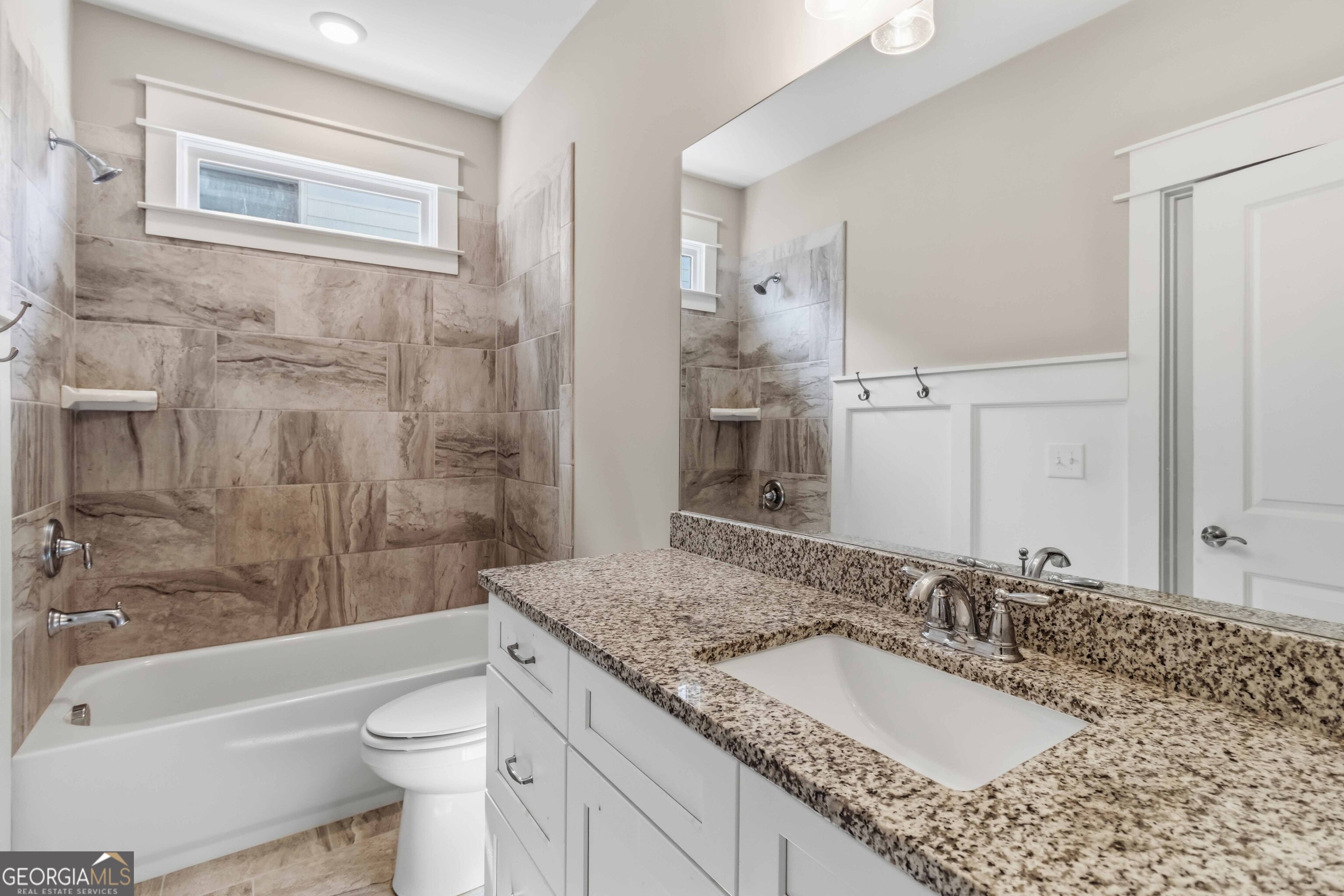 6247 Allen Ivey Road Mableton, GA 30126 - Photo 18 of 31 a bathroom with a granite countertop sink toilet mirror and bathtub