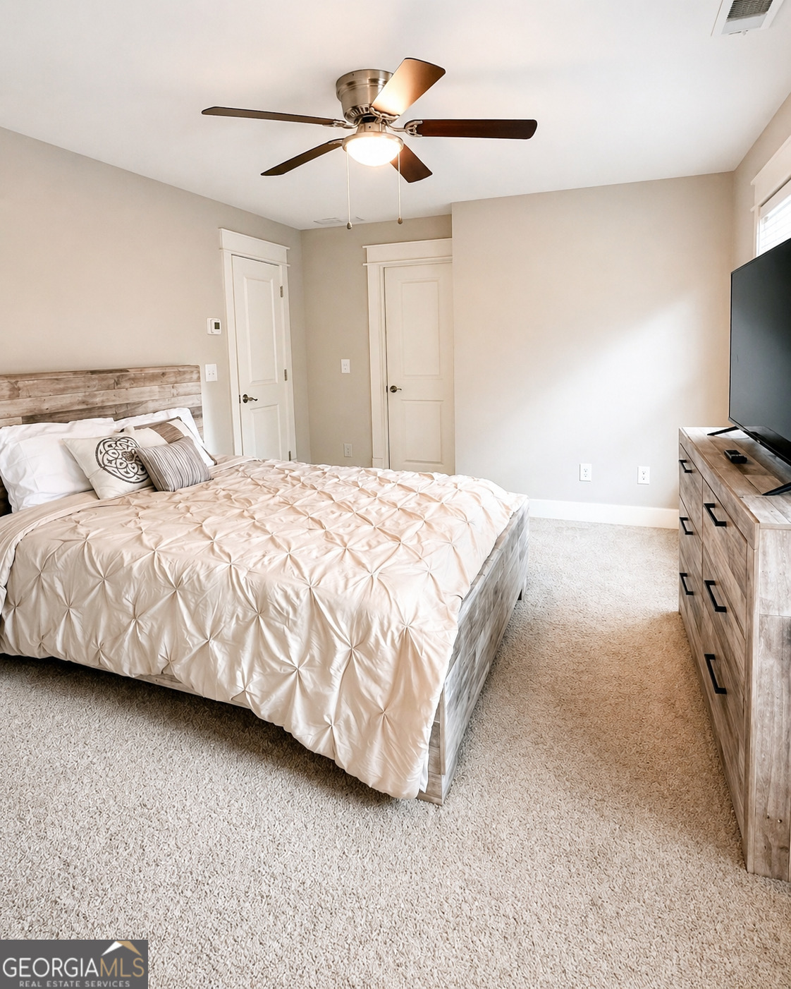6247 Allen Ivey Road Mableton, GA 30126 - Photo 19 of 31 a bedroom with a bed and a flat tv screen on dresser