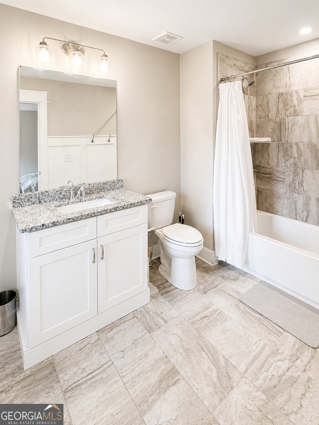 6247 Allen Ivey Road Mableton, GA 30126 - Photo 20 of 31 a bathroom with a granite countertop sink toilet a mirror a vanity and shower