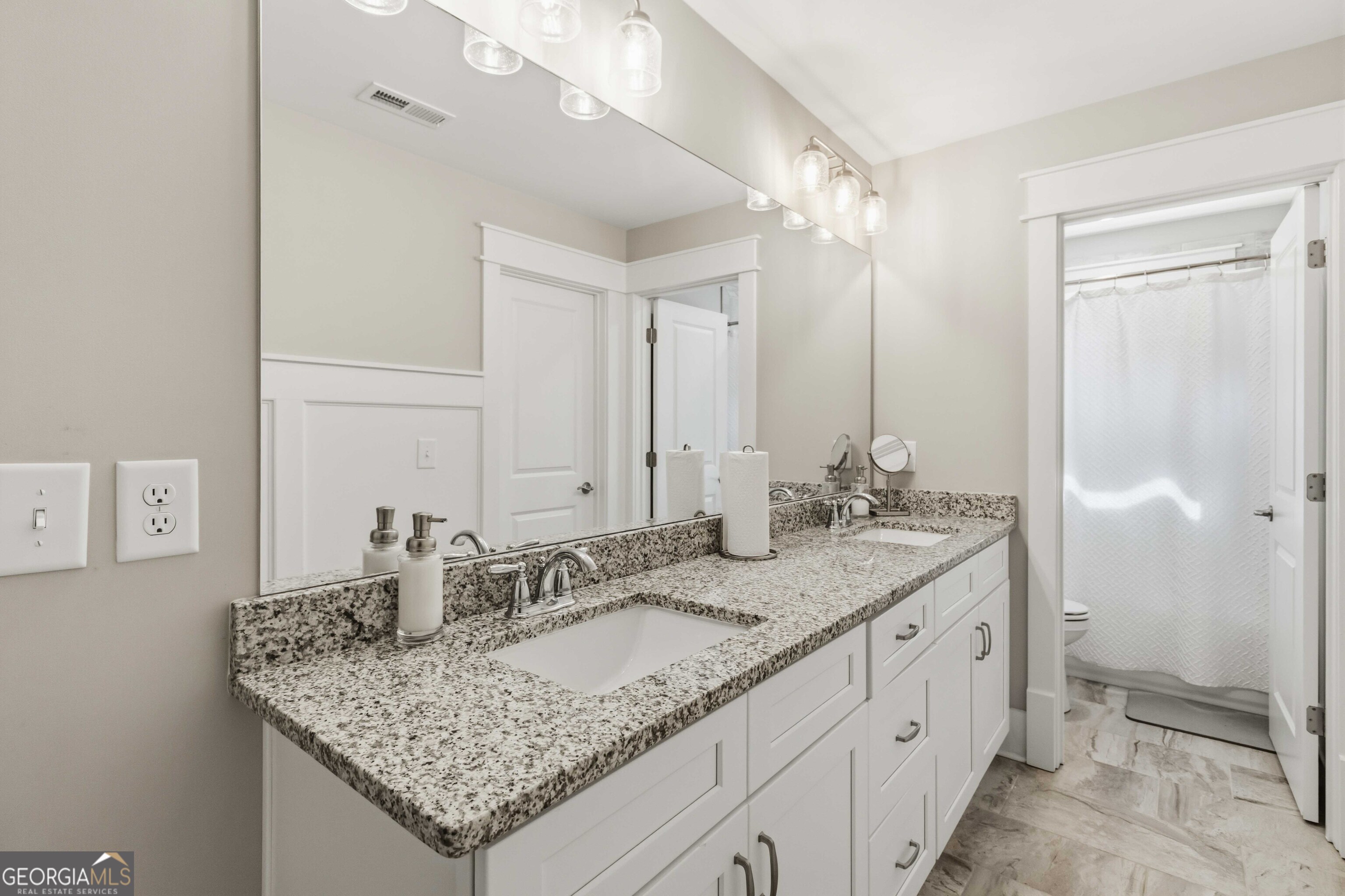 6247 Allen Ivey Road Mableton, GA 30126 - Photo 24 of 31 a bathroom with a granite countertop sink and a mirror