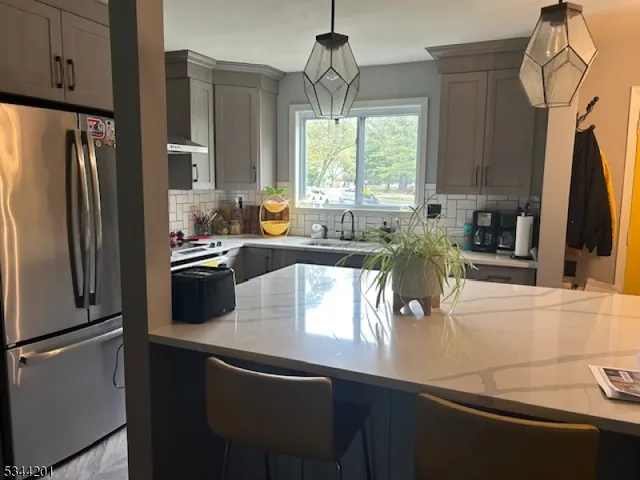 a kitchen with a sink a counter top space cabinets stainless steel appliances and a window