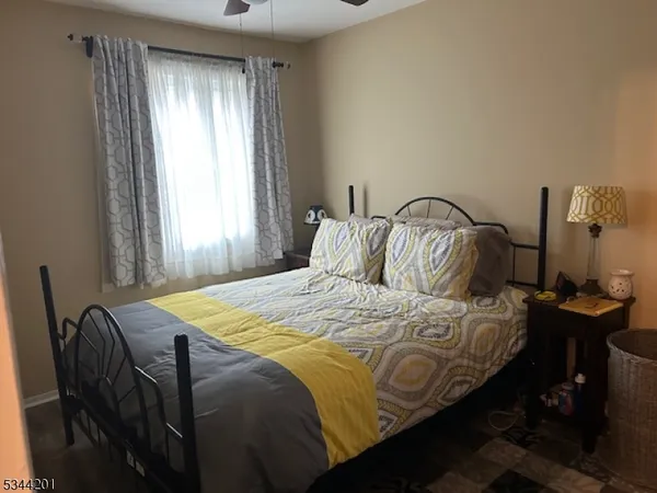 a bedroom with bed and a window