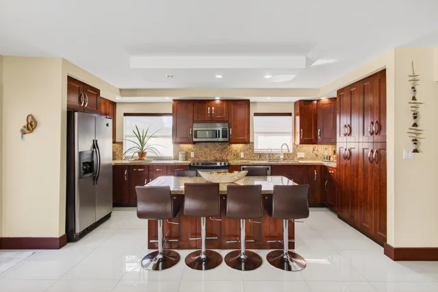 a kitchen with stainless steel appliances granite countertop a sink stove and microwave