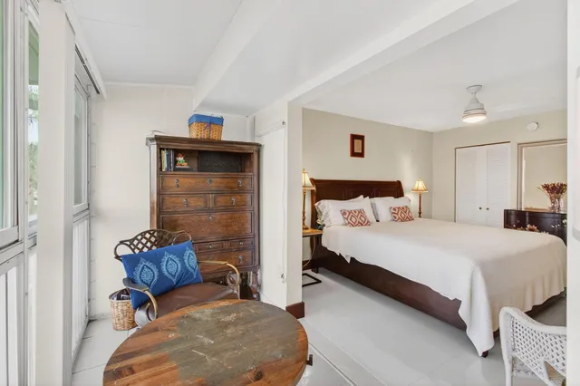 a view of a patio with table and chairs under an umbrella