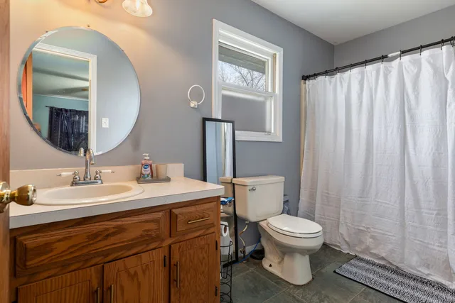 a bathroom with a toilet a sink and a mirror