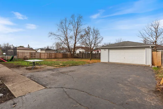 a view of a house with a yard and garage