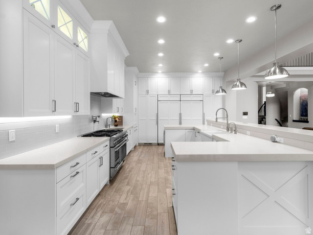 614 East High Lane Alpine, UT 84004 - Photo 35 of 75 Kitchen featuring white cabinetry, double oven range, pendant lighting, and light wood-style flooring