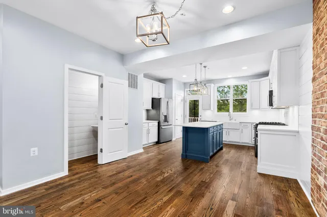 a large kitchen with a wooden floor and outdoor space