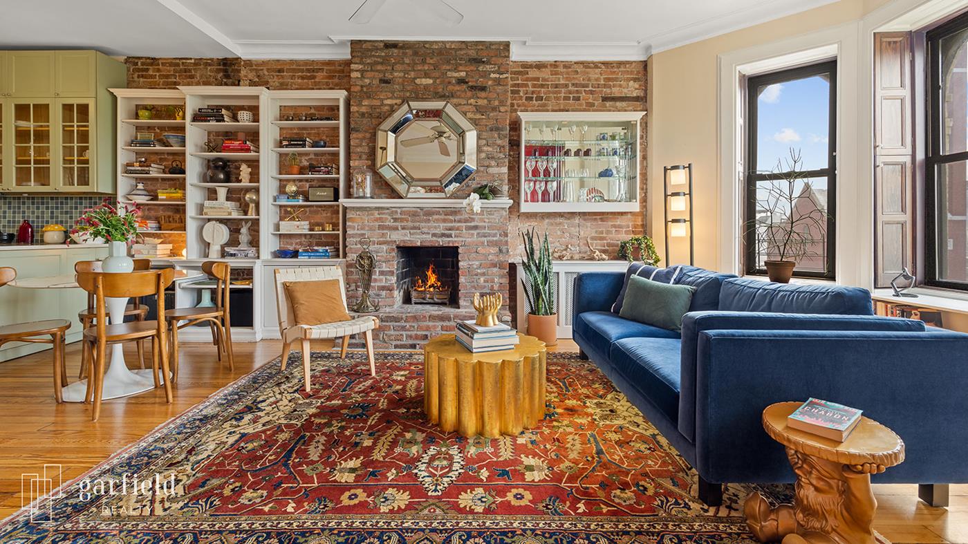 a living room with furniture a rug and a fireplace