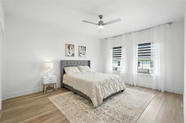 a bedroom with a large bed and a window