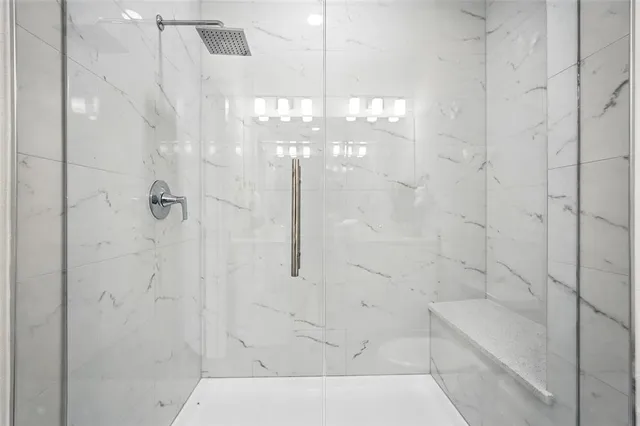 a bathroom with a bathtub and shower