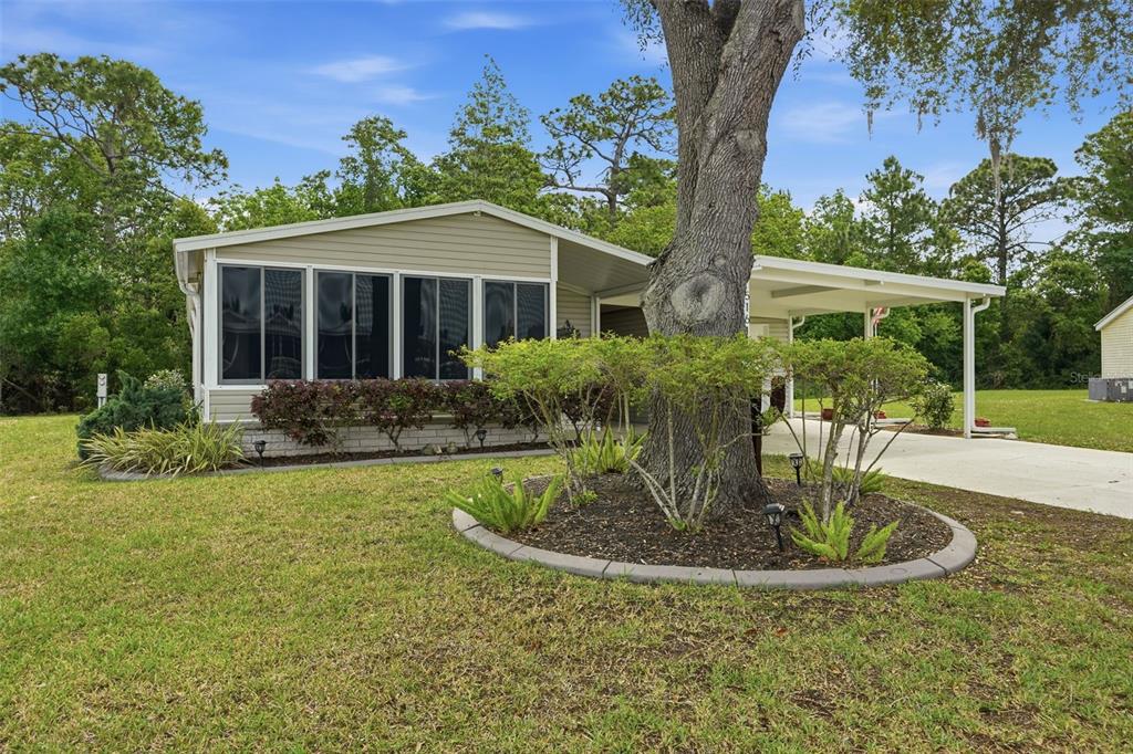 a view of a house with backyard sitting area and garden