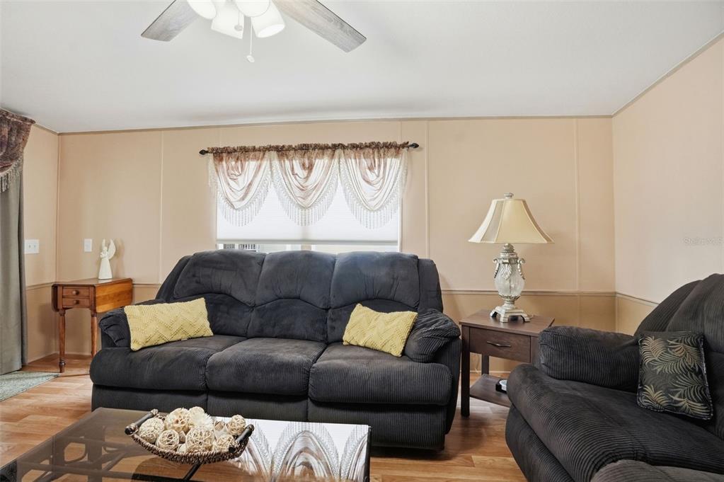 5161 Forest Glenn Drive Spring Hill, FL 34607 - Photo 13 of 51 a living room with furniture and a large window