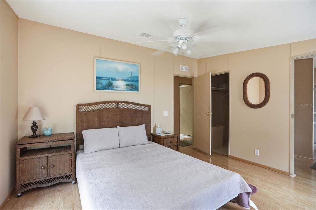 5161 Forest Glenn Drive Spring Hill, FL 34607 - Photo 19 of 51 a bedroom with a bed and a chandelier