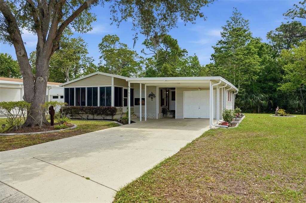 5161 Forest Glenn Drive Spring Hill, FL 34607 - Photo 2 of 51 front view of a house with a yard