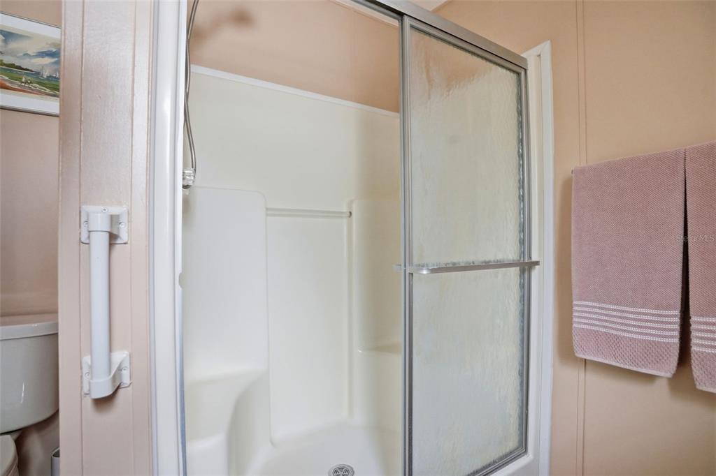 5161 Forest Glenn Drive Spring Hill, FL 34607 - Photo 24 of 51 a bathroom with a glass shower door