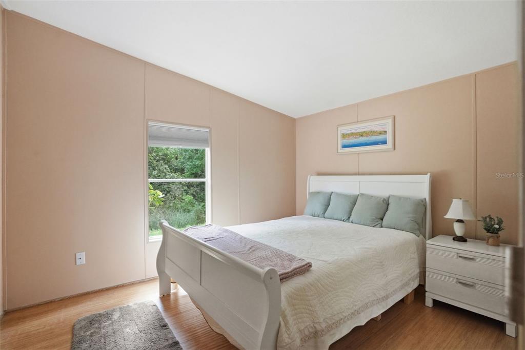 5161 Forest Glenn Drive Spring Hill, FL 34607 - Photo 25 of 51 a bed sitting in a bedroom next to a window