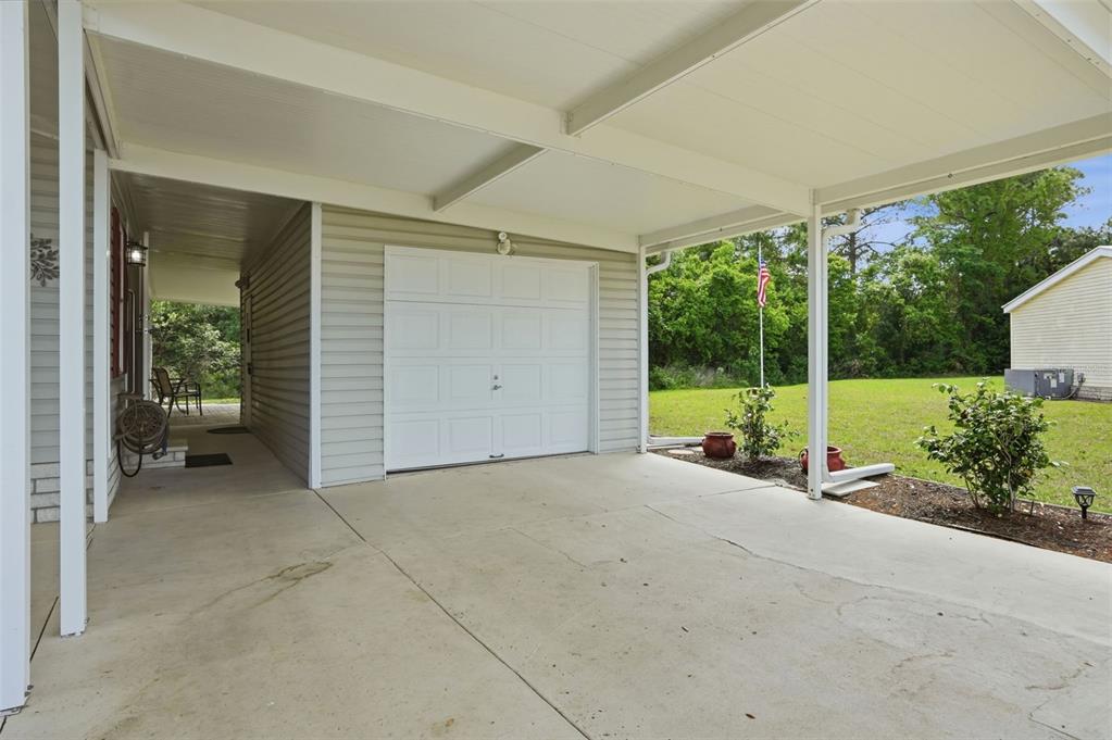 5161 Forest Glenn Drive Spring Hill, FL 34607 - Photo 40 of 51 an empty room with large windows and garden view
