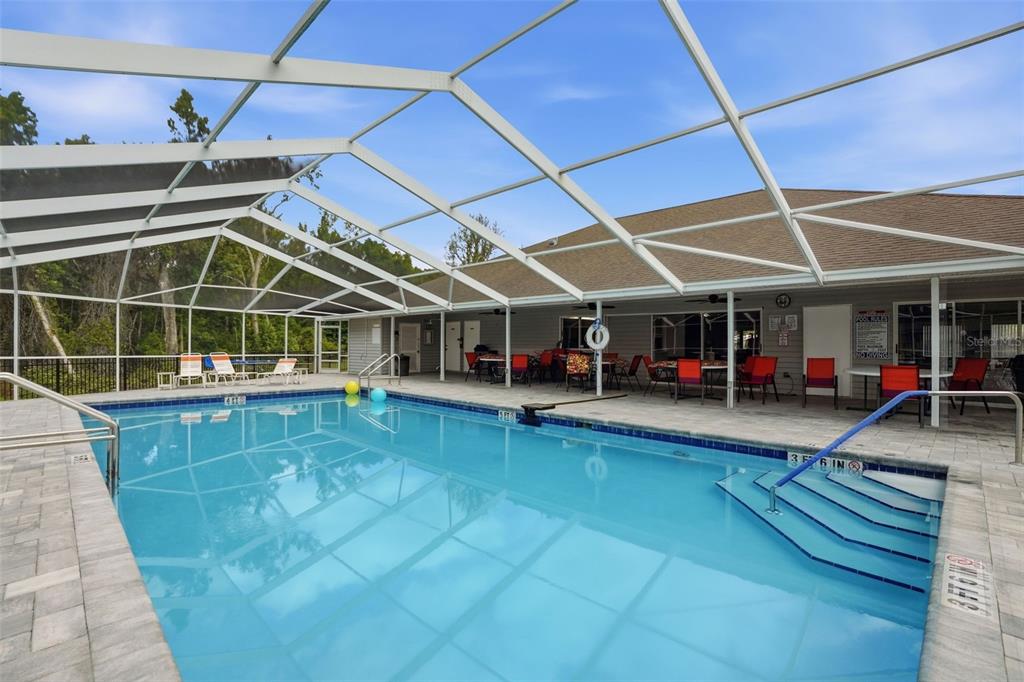 5161 Forest Glenn Drive Spring Hill, FL 34607 - Photo 44 of 51 a view of a swimming pool with seating space