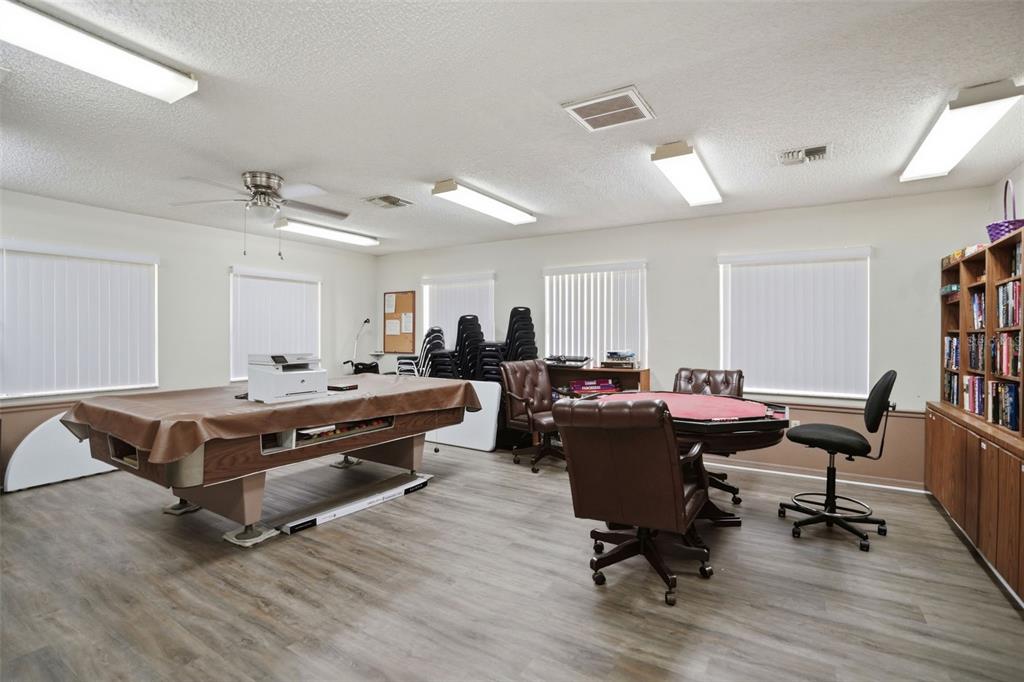 5161 Forest Glenn Drive Spring Hill, FL 34607 - Photo 50 of 51 a living room with furniture pool table and a wooden floor
