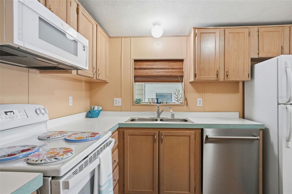 5161 Forest Glenn Drive Spring Hill, FL 34607 - Photo 6 of 51 a kitchen with kitchen island a sink stove and refrigerator
