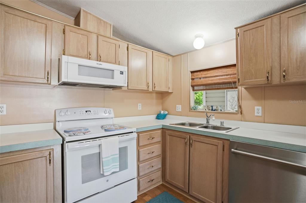 5161 Forest Glenn Drive Spring Hill, FL 34607 - Photo 7 of 51 a kitchen with a sink stove and cabinets