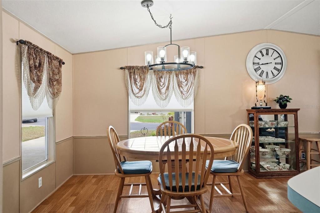 5161 Forest Glenn Drive Spring Hill, FL 34607 - Photo 8 of 51 a view of a dining room with furniture window and wooden floor