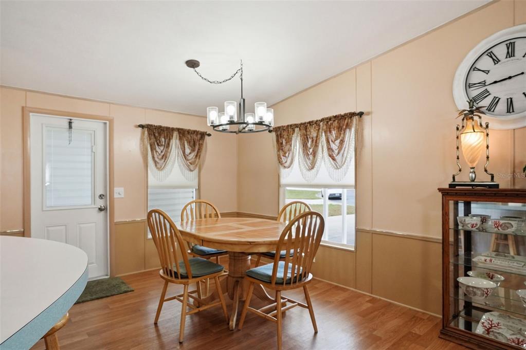 5161 Forest Glenn Drive Spring Hill, FL 34607 - Photo 9 of 51 a view of a dining room with furniture window and wooden floor