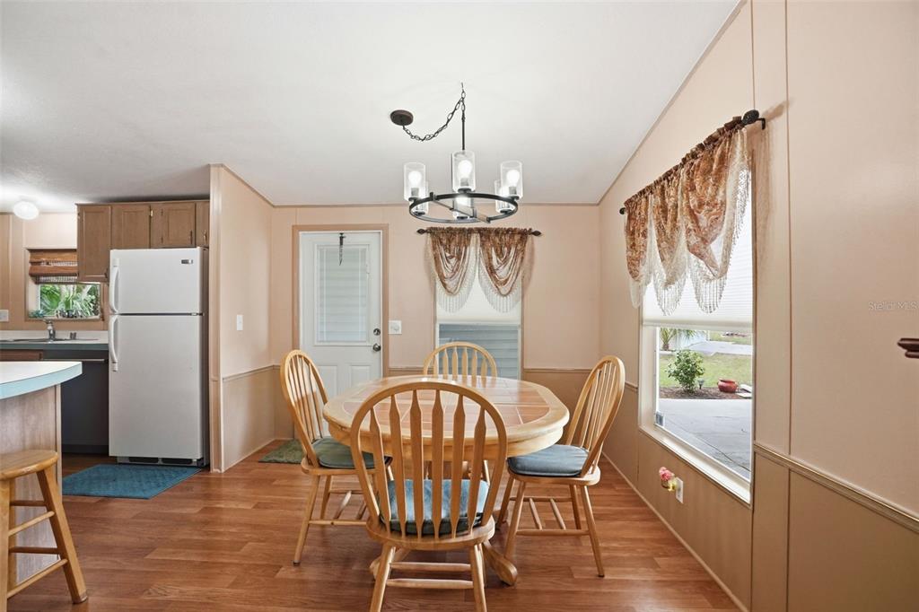 5161 Forest Glenn Drive Spring Hill, FL 34607 - Photo 10 of 51 a view of a dining room with furniture window and wooden floor
