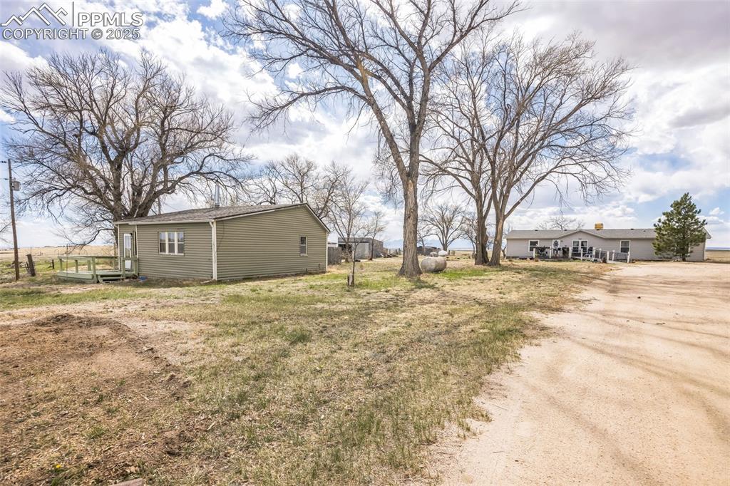 a view of yard covered with snow in front of house