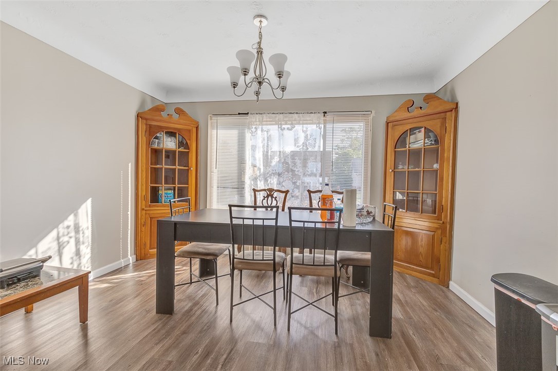 6136 Ridge Road Cleveland, OH 44129 - Photo 12 of 40 Dining space with wood finished floors and a chandelier