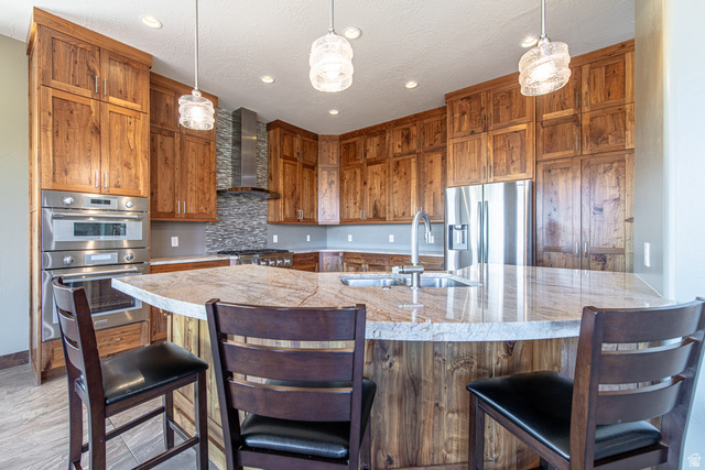 322 340 E Street Ivins, UT 84738 - Photo 12 of 61 Kitchen featuring a central island with a stone countertop, built-in sink, and pendant lighting