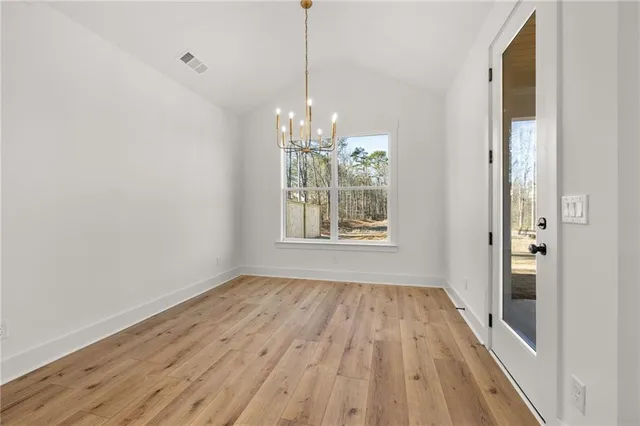 a view of a room with wooden floor and white doors