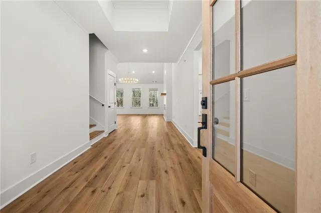 a view of hallway with wooden floor