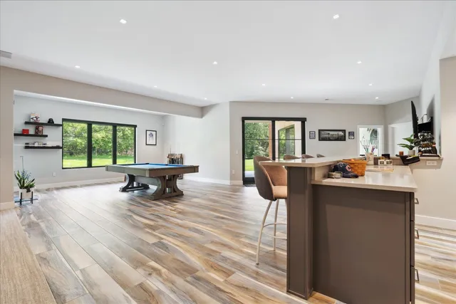 a living room with furniture and a large window with outer view