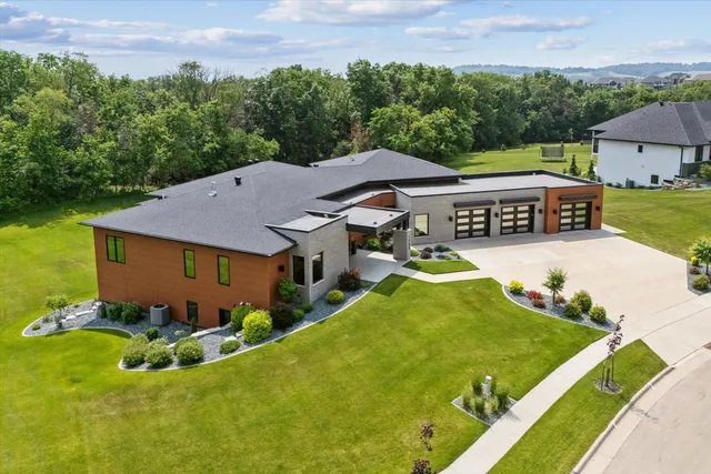 an aerial view of a house with swimming pool and garden