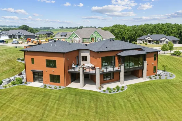a aerial view of a house with a yard table and chairs