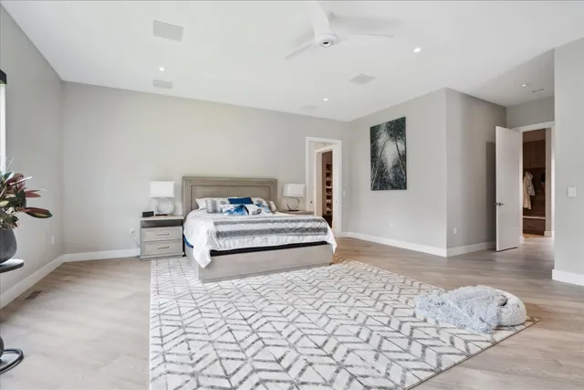 a bedroom with a bed and a mirror