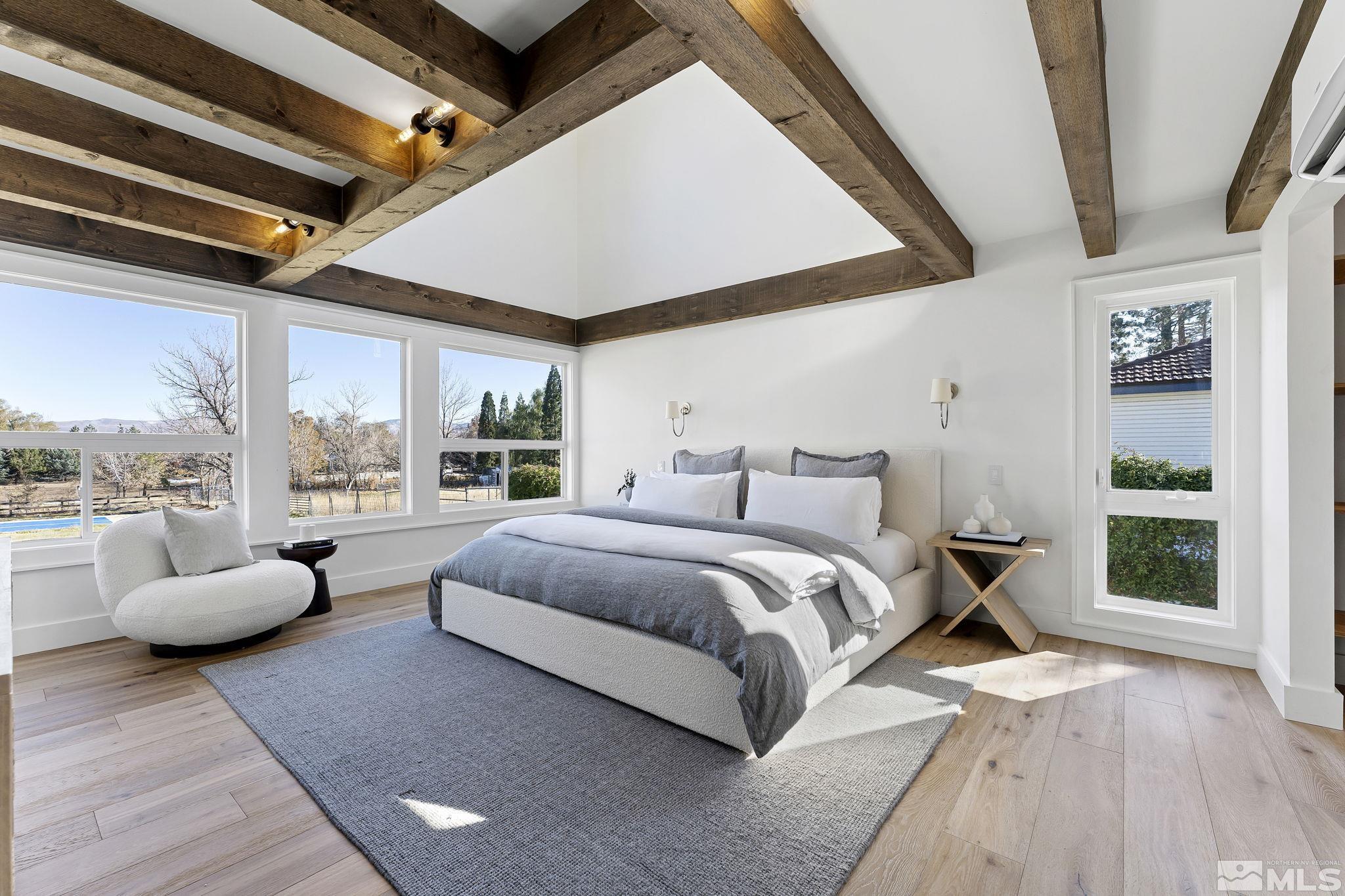 2620 Del Monte Lane Reno, NV 89511 - Photo 19 of 40 a spacious bedroom with a bed and glass window